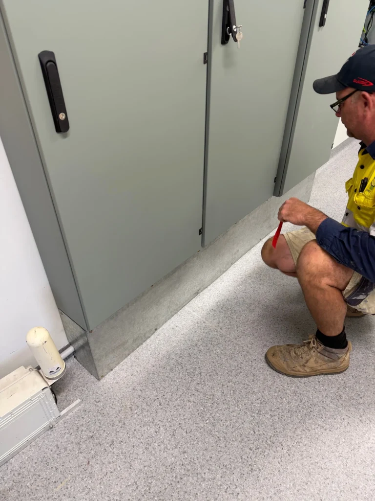 Electrician working at an electrical cabinet at Bega Sports Complex