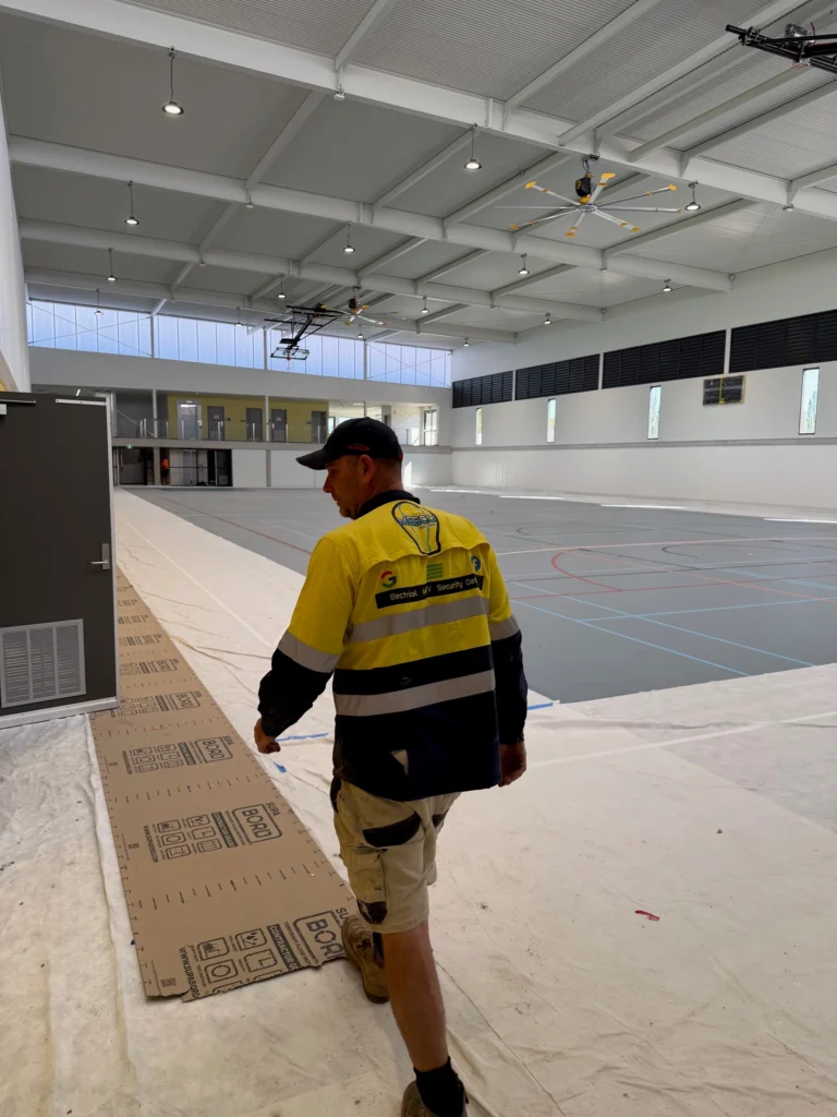 MESCO electrician in an interior fitout area at Bega Sports Complex