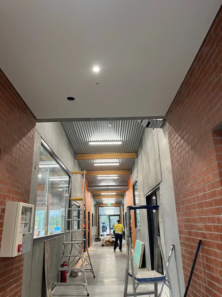 Carroll College corridor with ceiling lighting installed