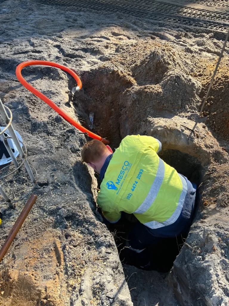 Electrician working in an excavation at Carroll College