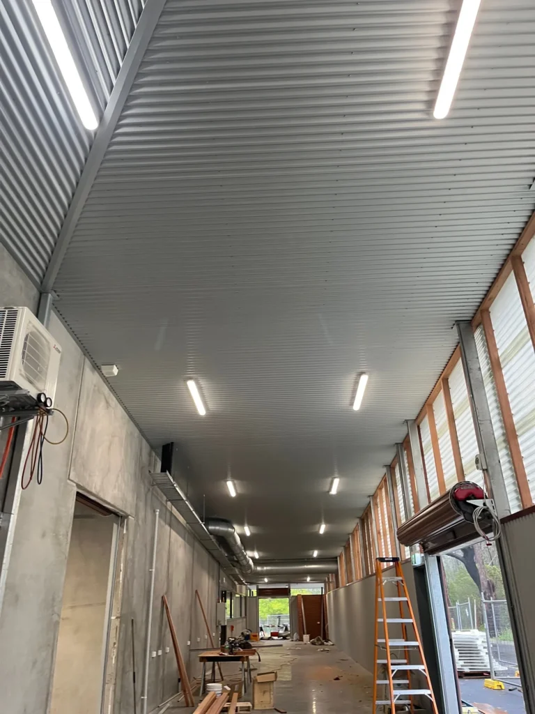 Ceiling lights along a corridor during Carroll College fitout