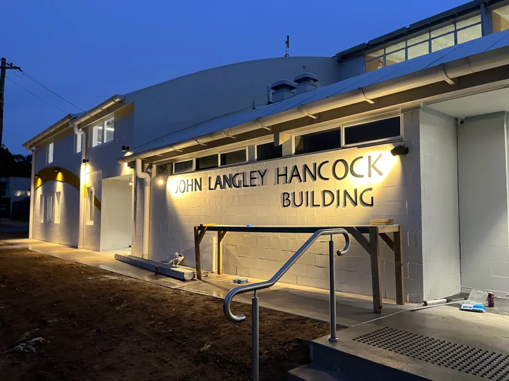 Langley Hancock Building entrance illuminated at dusk