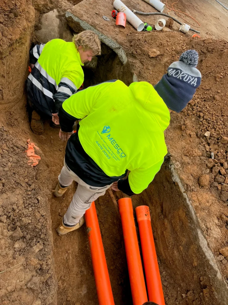 Electricians installing underground conduits at the Jindabyne training facility