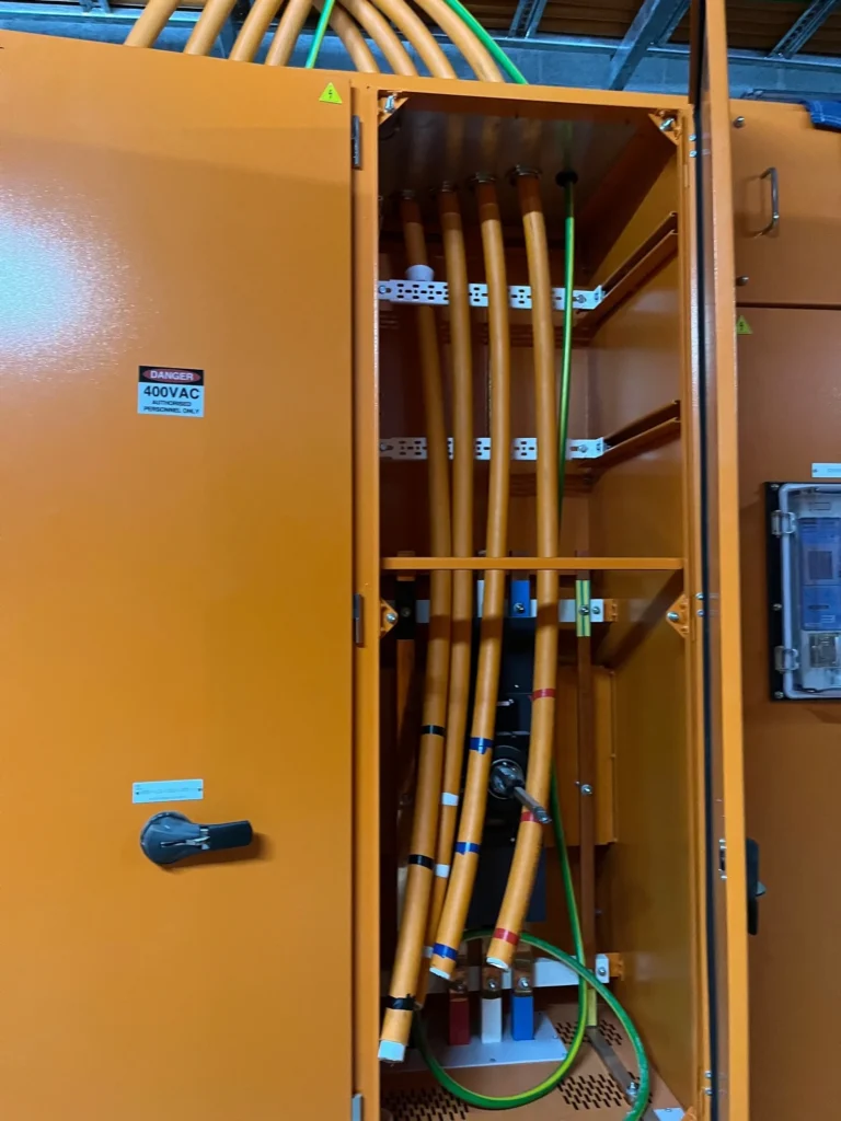 Orange submain cabling inside a hospital switchboard