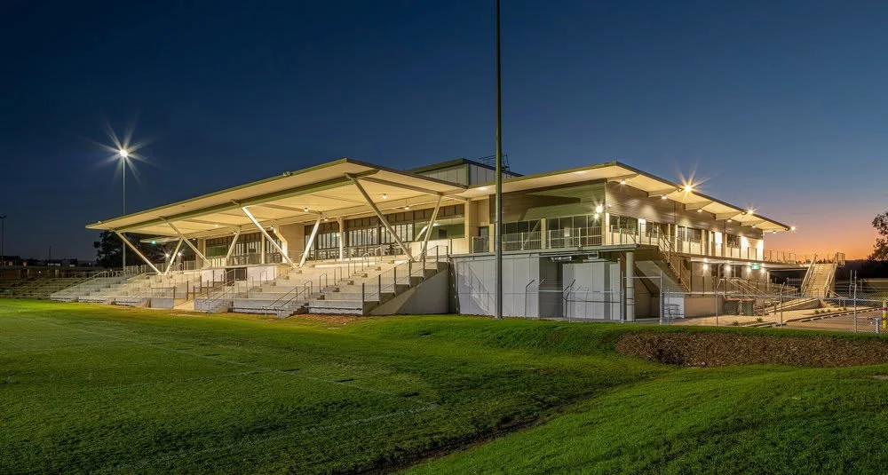 Bega Sports Complex stadium exterior illuminated at dusk