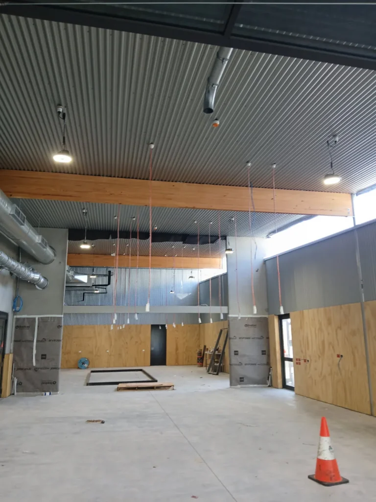 Carroll College hall interior during fitout with ceiling lights installed