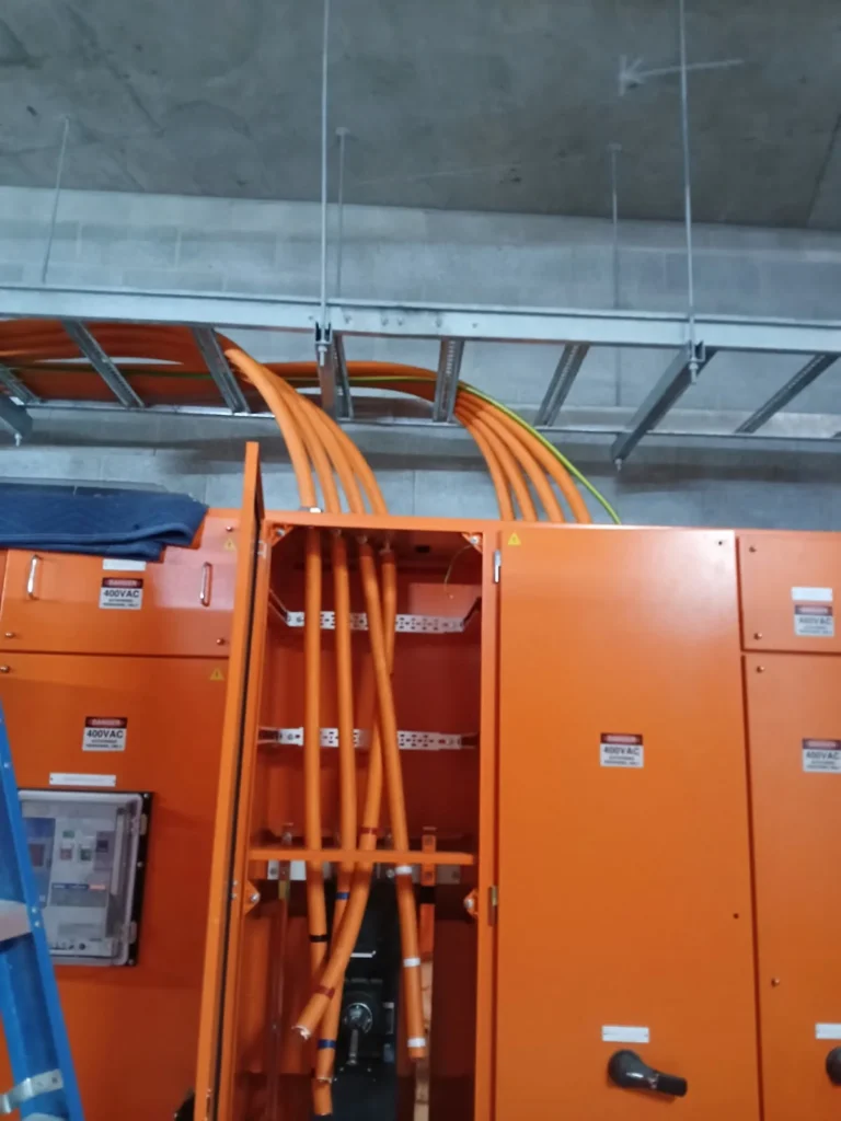 Orange submain cables entering an open switchboard at Eurobodalla District Hospital