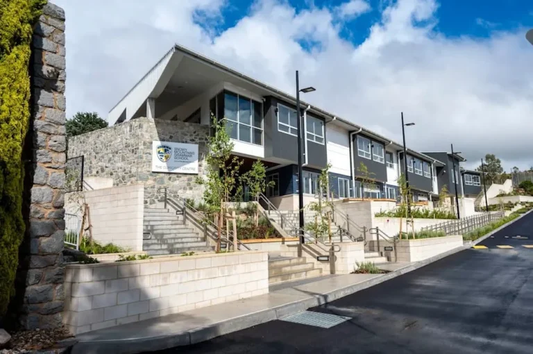 Snowy Mountains Grammar school building with stone entrance and exterior stairs